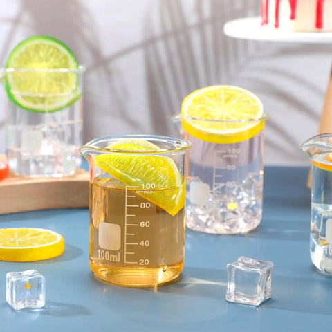 20 Pack 100 mL Glass Beaker Set Heavy Duty Lab Beakers With Printed Graduation showcasing drinks and citrus slices