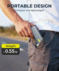 Person placing Powerful 130000 RPM Turbo Brushless Air Duster with Aluminum Alloy Body and Fast Charging into pocket outdoors.