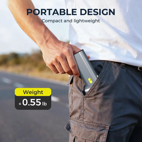 Person placing Powerful 130000 RPM Turbo Brushless Air Duster with Aluminum Alloy Body and Fast Charging into pocket outdoors.