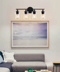 Four Light Matte Black Bath Vanity Light With Clear Glass Shades Industrial Farmhouse Sleek Modern Wall Sconce above a sofa