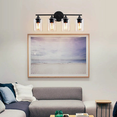 Four Light Matte Black Bath Vanity Light With Clear Glass Shades Industrial Farmhouse Sleek Modern Wall Sconce above a sofa