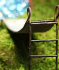 Miniature Rustic Metal Slide For Fairy Garden Bench And Backyard Micro Landscape Set featuring a close-up view of the metal slide ladder.