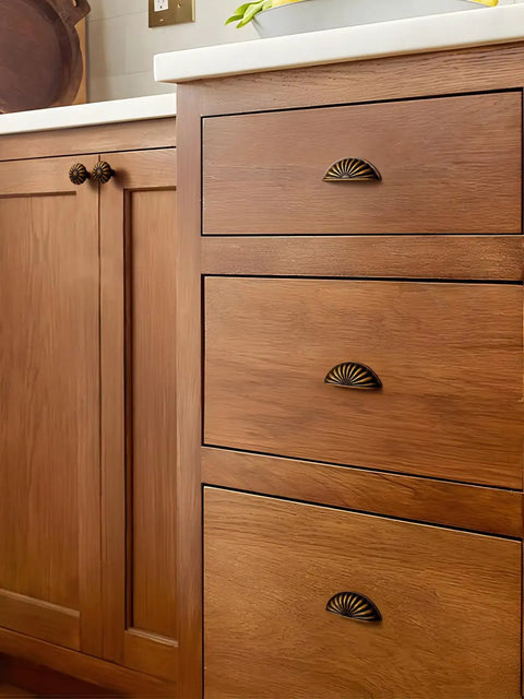 Rock Solid Antique Brass Cup Pulls For Kitchens And Dressers Heavy Duty Zinc Alloy Vintage Drawer Handles Built Tough With 2.5 Inch Center To Center Spacing Quick Install shown on wooden drawers.
