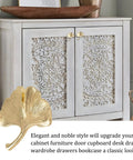 Six Piece Ginkgo Leaf Cabinet Knobs And Solid Zinc Drawer Pulls In Rustproof Brushed Gold Finish on a white cupboard with intricate design.