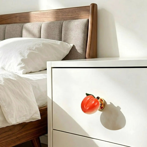 Adorable 3D Peach Cabinet Knobs And Drawer Pulls For A Fresh Playful Home Vibe on a white dresser beside a cozy bed.