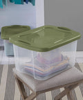 Heavy Duty 2 Pack 40 Quart Clear Plastic Storage Bins Stackable Totes With Secure Snap Lids And Grip Carry Handles on a chair.