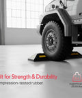 Truck parked with Beefy Two Pack Heavy Duty Rubber Wheel Stops For Garage Parking, Durable High Density Rubber, High Visibility Reflective Strip, 33,000 Lb Capacity Per Stop.