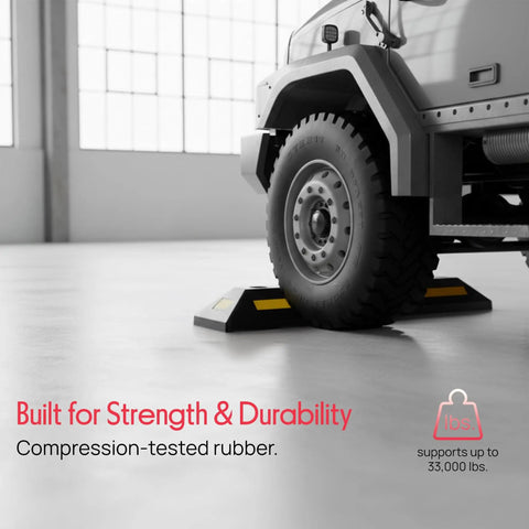 Truck parked with Beefy Two Pack Heavy Duty Rubber Wheel Stops For Garage Parking, Durable High Density Rubber, High Visibility Reflective Strip, 33,000 Lb Capacity Per Stop.