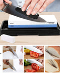 Person using Pro-Grade Knife Sharpening Stone Set With Dual Sided 1000/6000 Grit Waterstone, Angle Guide, Non-Slip Base Holder
