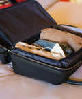 Carry On Ready Duffle Travel Bag With Clamshell Opening, 33 Liter Capacity, showcasing open bag with clothes inside on a bed.