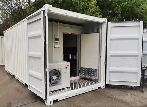 Heavy Duty Industrial Walk In Freezer Cold Room With Energy Efficient Blast Cooling System Built Like A Tank For High Volume Food Processing And Warehousing No Fuss Operation, exterior view showing open doors and cooling unit.