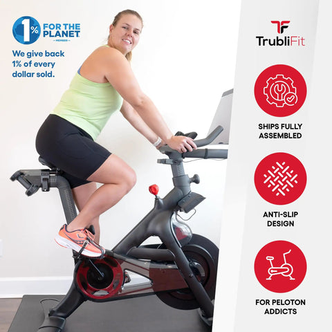Person using bike with Dual Function Toe Cages For Peloton Pedals So You Can Roll In Sneakers Or Peloton Shoes And Switch Shoes