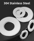 304 stainless steel flat washers in various sizes; round discs with central holes (close-up view)