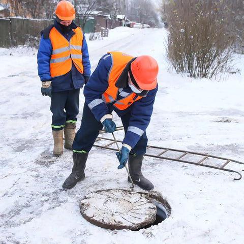 Worker using Stainless Steel T Hook Well Cover Hook For Manholes Pro Grade Heavy Duty Lift Tool to open a manhole