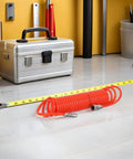 Rad Awesome Recoil Air Compressor Hose 6 Meter 19 Point 7 Foot Retractable Spring Line With Connector For Heavy Duty Shop Use Leakproof Seal Keeps Your Setup Safe Solid Construction Makes Transport A Cinch Reliable Performance For Every Job Now, orange coil hose on workshop floor