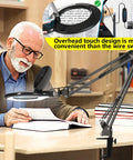 Man using 10X Magnifying Glass With Light And Stand Great For Close Work And Crafts, 2200 Lumen LED Desk Lamp at desk