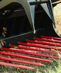 Close-up of 72 Inch Manure Tine Grapple Bucket Attachment With SSQA Hay Spear Frame And Double Grapple Rake Arms on grass