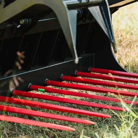 Close-up of 72 Inch Manure Tine Grapple Bucket Attachment With SSQA Hay Spear Frame And Double Grapple Rake Arms on grass