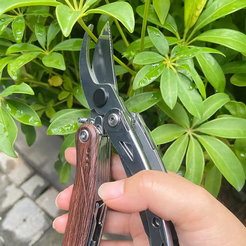7 In 1 Garden Pruning Shears Folding Multitool With 8 Inch Professional Garden Scissors held in hand cutting plant