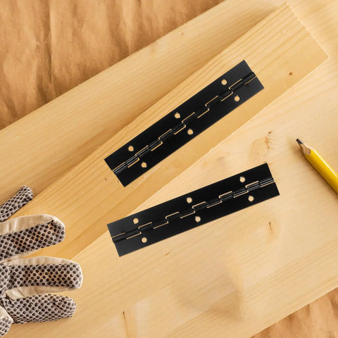 Heavy Duty Iron Piano Hinges Set For Doors And Cabinets, 6 inch black hinges on wooden surface with pencil and glove