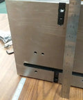 Close-up of Precision Tilting Rotary Table with Three Jaw Chuck and Six Inch Centering Adapter showing metal surface and ruler measurements.