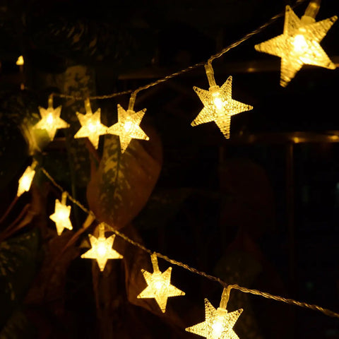 Warm White 50 LED Five Point Star Fairy Lights glowing indoors, battery-powered, highlighting 1.6 inch star beads
