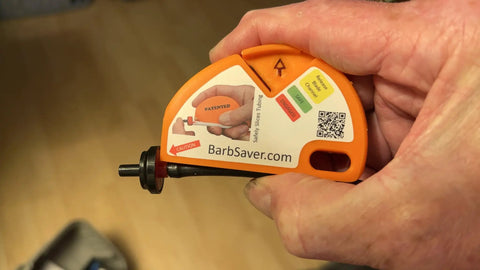 Close-up of Drip Irrigation Cutter Tool For One Quarter Inch Micro-Drip Tubing Quick Safe Slice in hand showing ergonomic design.
