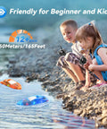 Children playing with Remote Control RC Boat Set For Pool And Lake Play In A 2 Pack, Whole Body Waterproof Water Toy at lake edge