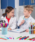 Children with 48 Pieces Science Pens Bulk Set With 12 Designs Black Ink 0.5mm Ballpoint Pens in a science lab setting