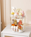 Two Tier Clear Rotating Vanity Organizer With Smooth 360 Degree Spin For Skincare And Perfume Beauty Essentials Storage on a dresser.