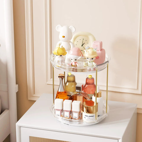 Two Tier Clear Rotating Vanity Organizer With Smooth 360 Degree Spin For Skincare And Perfume Beauty Essentials Storage on a dresser.