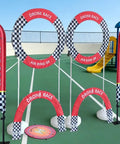 FPV Drone Racing Kit With DIY Obstacle Course For Indoor And Outdoor Use setup on an outdoor court with 3D hoops and flags.