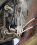 Close-up of Mini-Ductor Bearing Buddy coil MD99-603 with braided insulated wires wrapped around a metal bearing housing.
