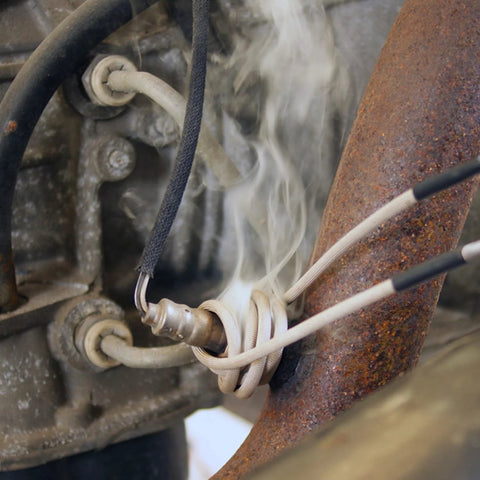 Close-up of Mini-Ductor Bearing Buddy coil MD99-603 with braided insulated wires wrapped around a metal bearing housing.