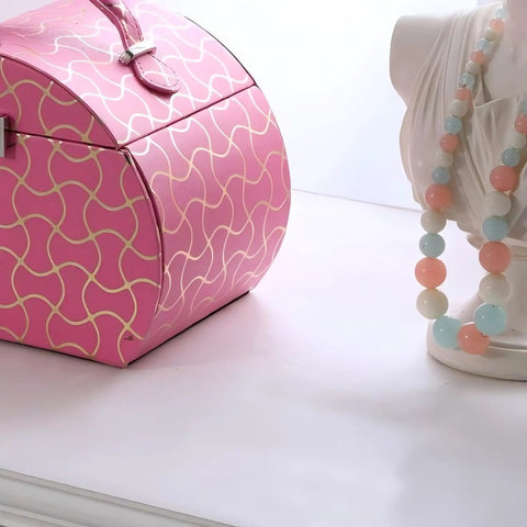 Eight Point Eight Inch Hot Pink Travel Jewelry Organizer Case With Built In Mirror And Snug Pockets To Keep Your Bling Safe During Any Weekend Dash Or Cross Country Drive displayed next to a decorative bust with colorful beads.