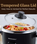 6-Cup Electric Rice Cooker With Stainless Steel Inner Pot and tempered glass lid, black, with cooked rice showing inside