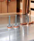 Heavy Duty Swivel Leveling Feet With GripLock Rubber Base And Easy Tune Bolts For Sturdy Workbenches And Garage Rigs D60x12mm Rock Solid Pack Of Two on a metal surface.