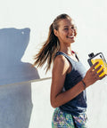 Woman holding Flat Square Water Bottle For On The Go Hydration, Leak Proof And Drop Proof, Pocket And Purse Friendly Portable Hydration Bottle