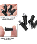 24 Pack Black Plastic Cabinet Door Repair Pins Heavy Duty Spring Loaded Damper Replacement Hardware For Kitchen Cabinets And Furniture Quick Snap No Fuss Axis Connector in hand showing size and design.