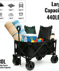 Heavy Duty Collapsible Folding Wagon With Built In Table loaded with beach gear and chairs, 440 lb capacity, black color.