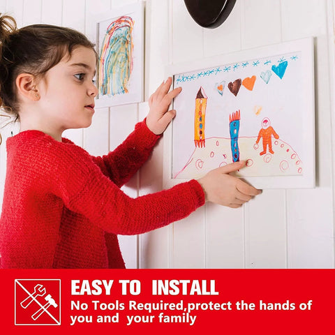 Double-sided heavy-duty adhesive mounting tape; front view of a child hanging artwork on a white wall.