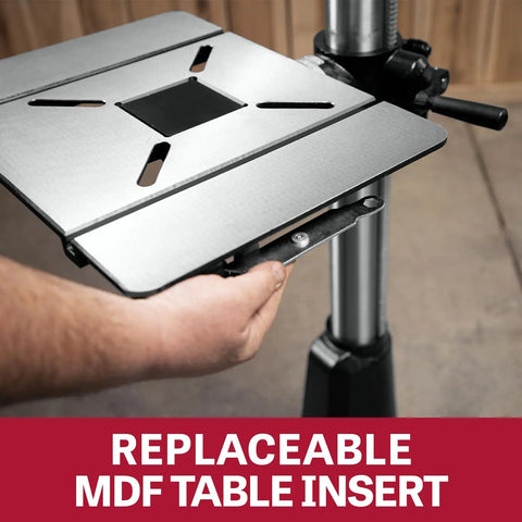 Hand holding the replaceable MDF table insert of the Shop Beast 17 Inch Floor Drill Press With 16 Variable Speeds And A Powerhouse 3/4 Horsepower Motor.