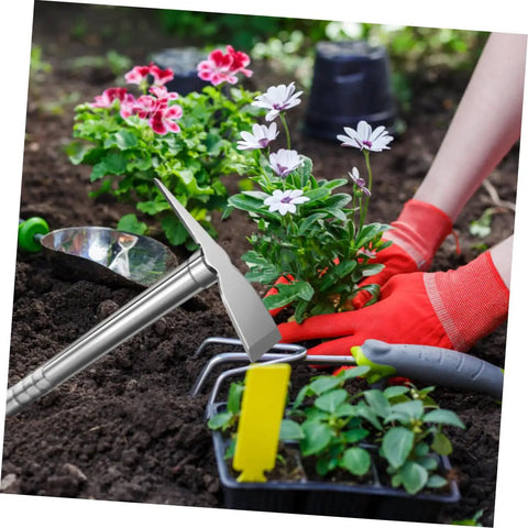 Person planting flowers with a Stainless Steel Garden Hoe Tool With Ergonomic Handle For Quick Weeding And Digging In Vegetable Gardens