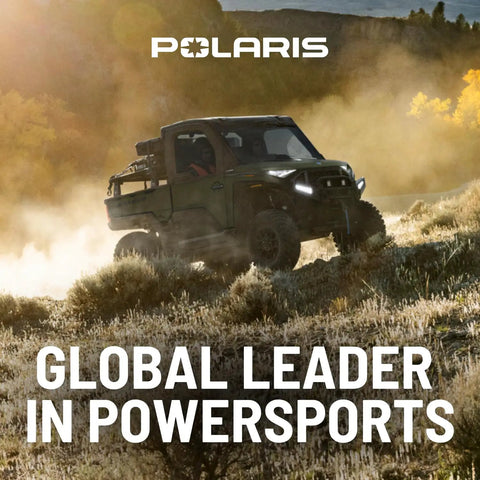 Polaris off-road vehicle driving through dusty landscape, showcasing power and performance. Global Leader in Powersports.