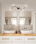 Tempo Foldable Track Lighting Bar With 4 Pivoting Joints In Matte Black Finish 5 Light Adjustable Track Light mounted in a modern bathroom.