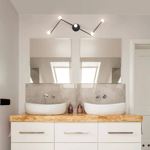 Tempo Foldable Track Lighting Bar With 4 Pivoting Joints In Matte Black Finish 5 Light Adjustable Track Light mounted in a modern bathroom.