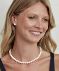 Woman wearing Japanese Akoya Pearl Pendant Necklace For Women, 8.5-9mm White Cultured Pearl AA+ Grade, 14K Yellow Gold, 18 Inch Chain.