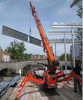 Mini Portable Crawler Crane Rig With Smart Wireless Remote Hydraulic Lift Machine Fully Kitted Out lifting steel beams over a canal.