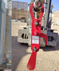 3 Ton Automatic Decoupling Lifting Hook For Forklifts in thickened alloy steel, shown attached to forklift, construction site in background.