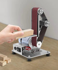 Heavy Duty 110 V Mini Bench Belt Sander Grinder polishing a wood block with adjustable speed and stainless steel build.